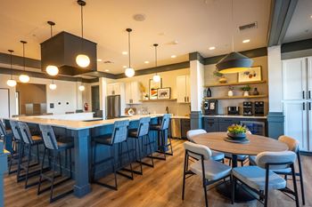 A modern kitchen with a large island and bar stools.